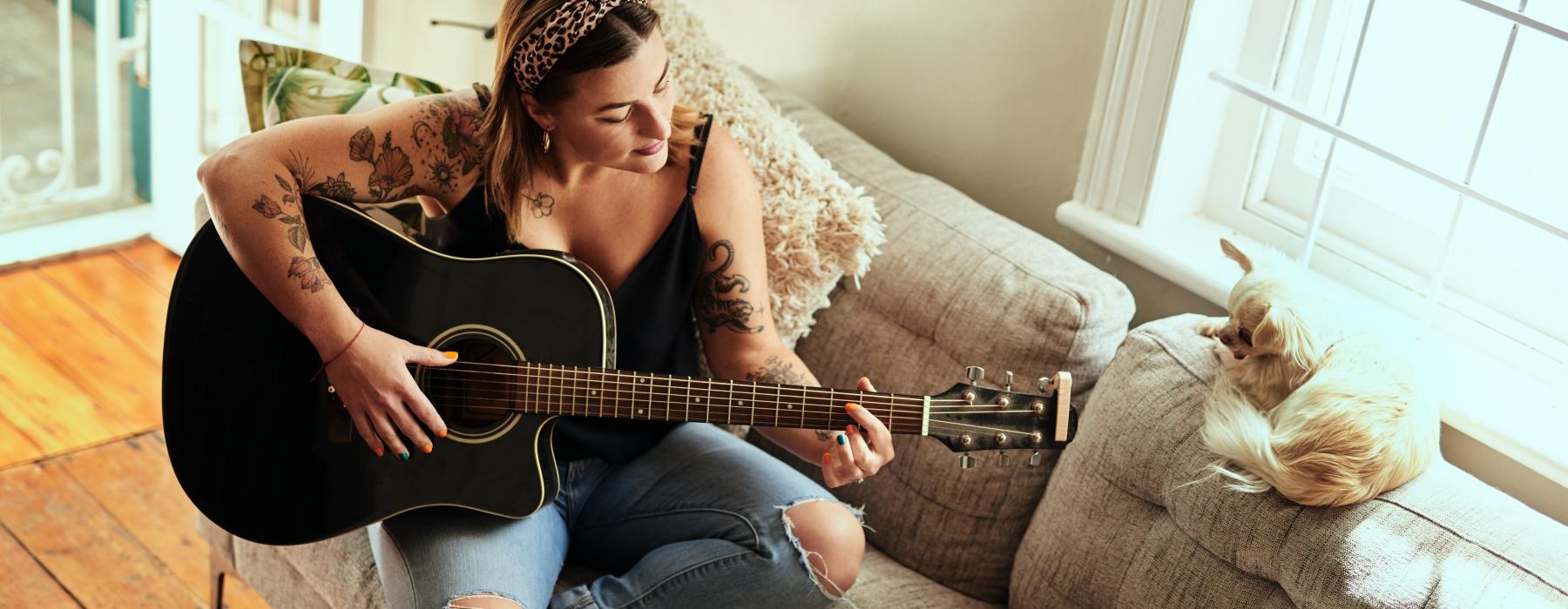 a woman playing a guitar